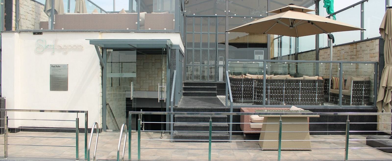 Rooftop swimming pool with a lounge area in the background at BluSalzz Residence, Amritsar.